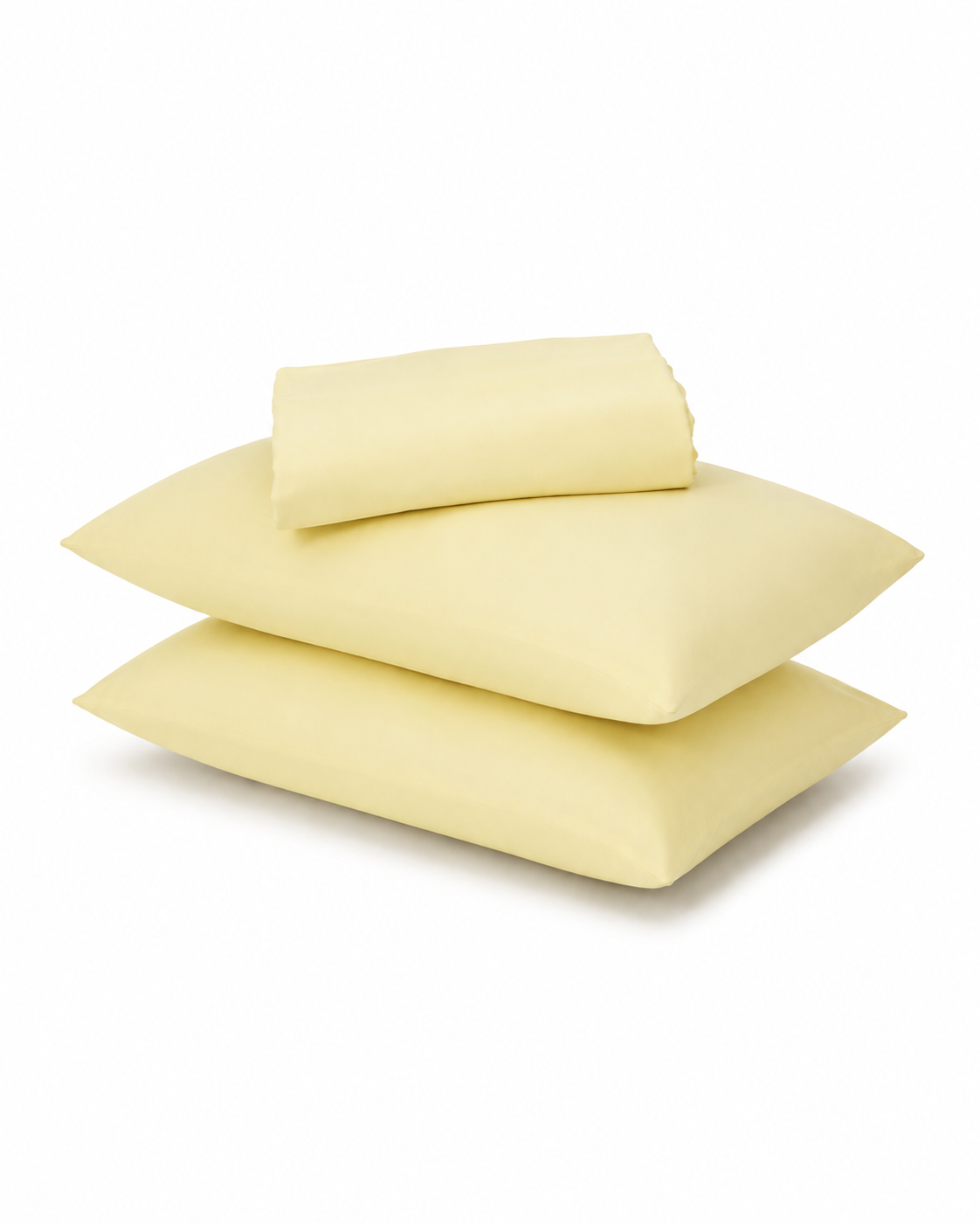 Three pale yellow pillows and a matching folded sheet or pillowcase stacked on a white background.
