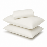 Three off-white pillows, including two flat square pillows and one rolled pillowcase, stacked on a white background.