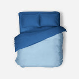 Blue bedding set with duvet and pillows on a white background