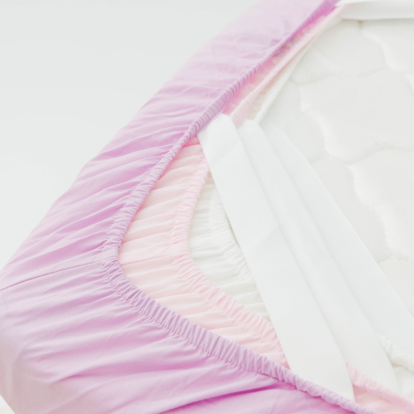 Close-up of a pink and white fabric with a gradient effect on a light gray background